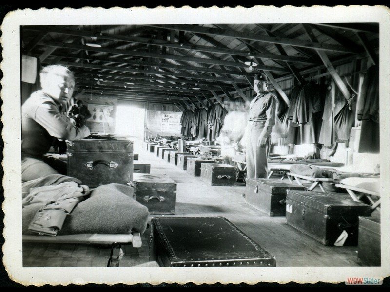 1942-09-06 Mines Field - My bunk is back of the footlocker with a tag on it. The inside of our barracks. You can see Shorty on the side of Joe. Taken with time and it would stop him. Cowboy is writing a letter, he moved too.