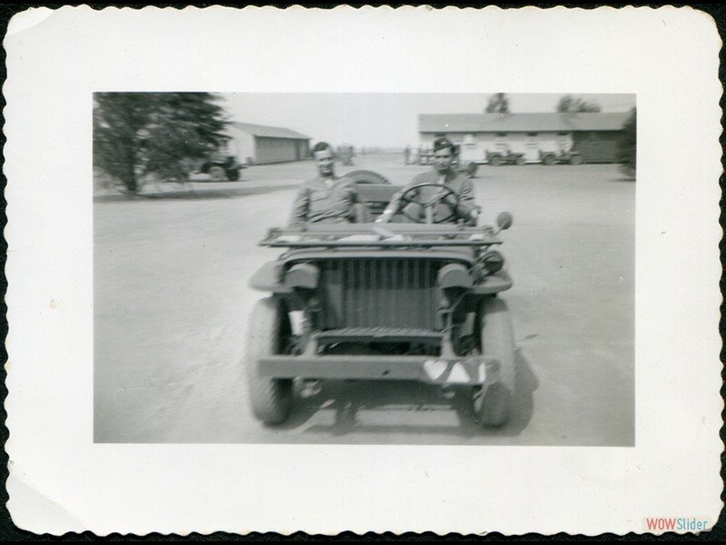 1942-09-27 Mines Field - My Jeep, we were moving but the fellow who took the picture moved the camera. The other fellow is Cameron.  He drives the major in the command car.